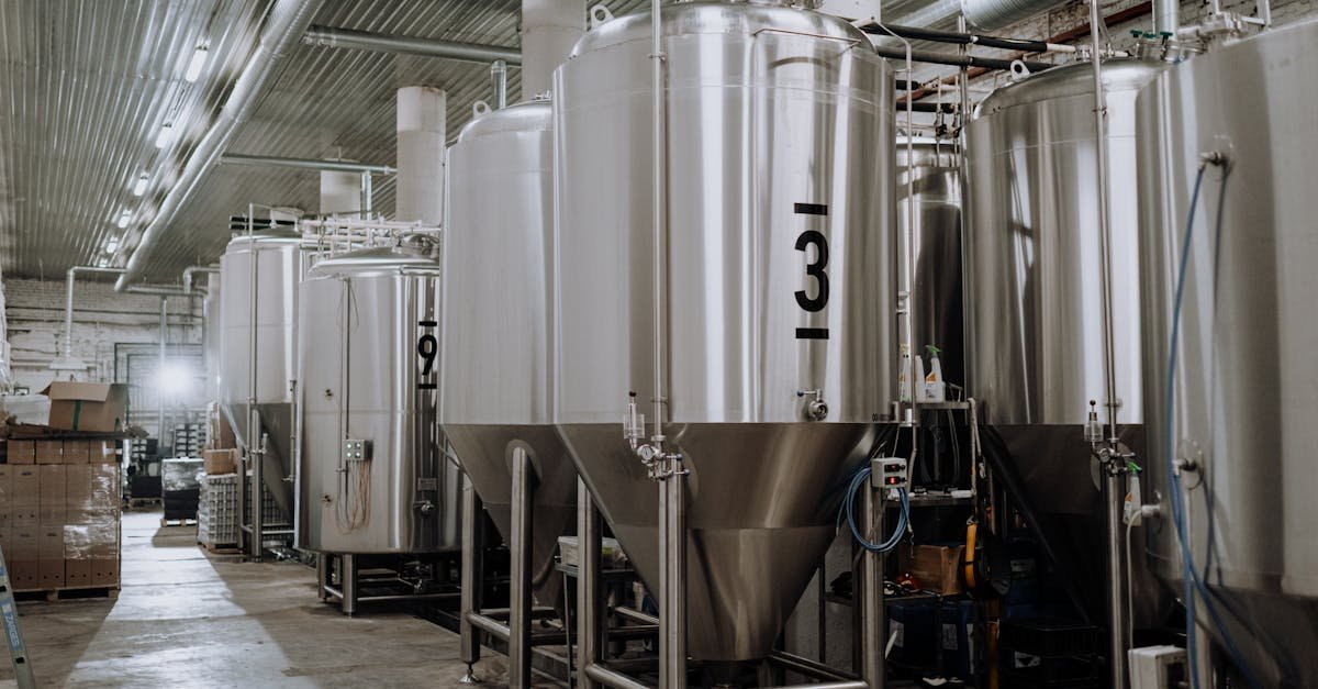 Interior view of a modern brewery showcasing stainless steel fermentation tanks.